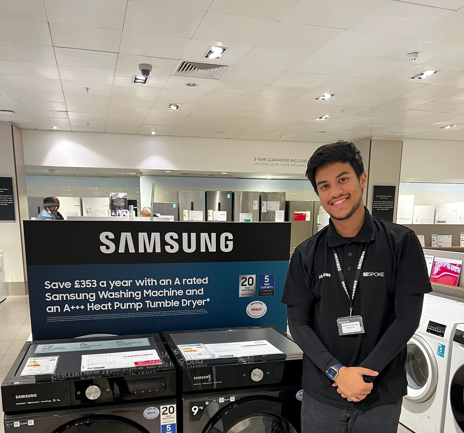 man standing in front of Samsung appliance in store